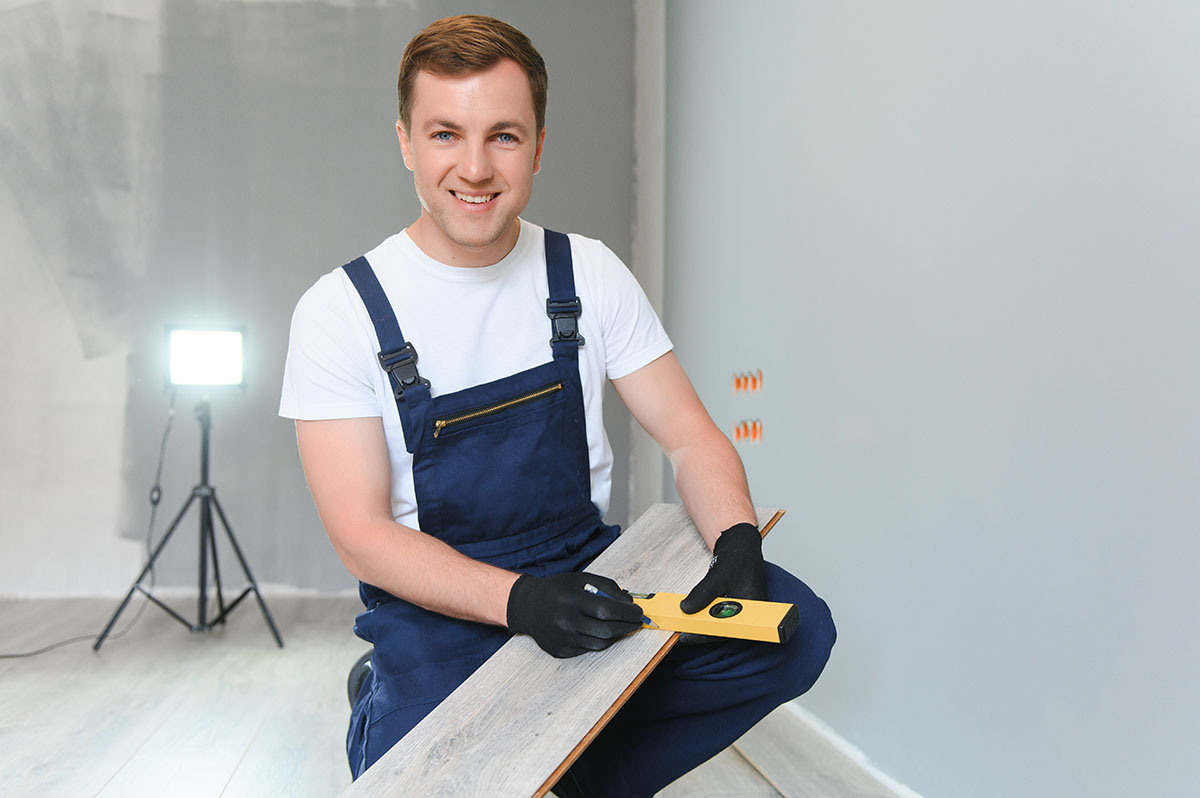 Man Installing New Laminated Wooden Floor