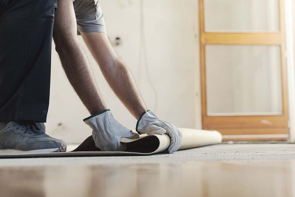 Contractor Removing An Old Linoleum Flooring