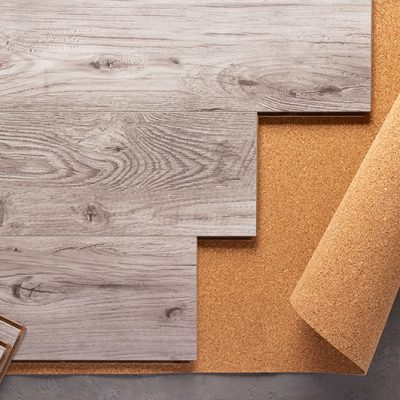 Laminate wood floor on cork background texture. Wooden laminate floor and corkboard with copy space